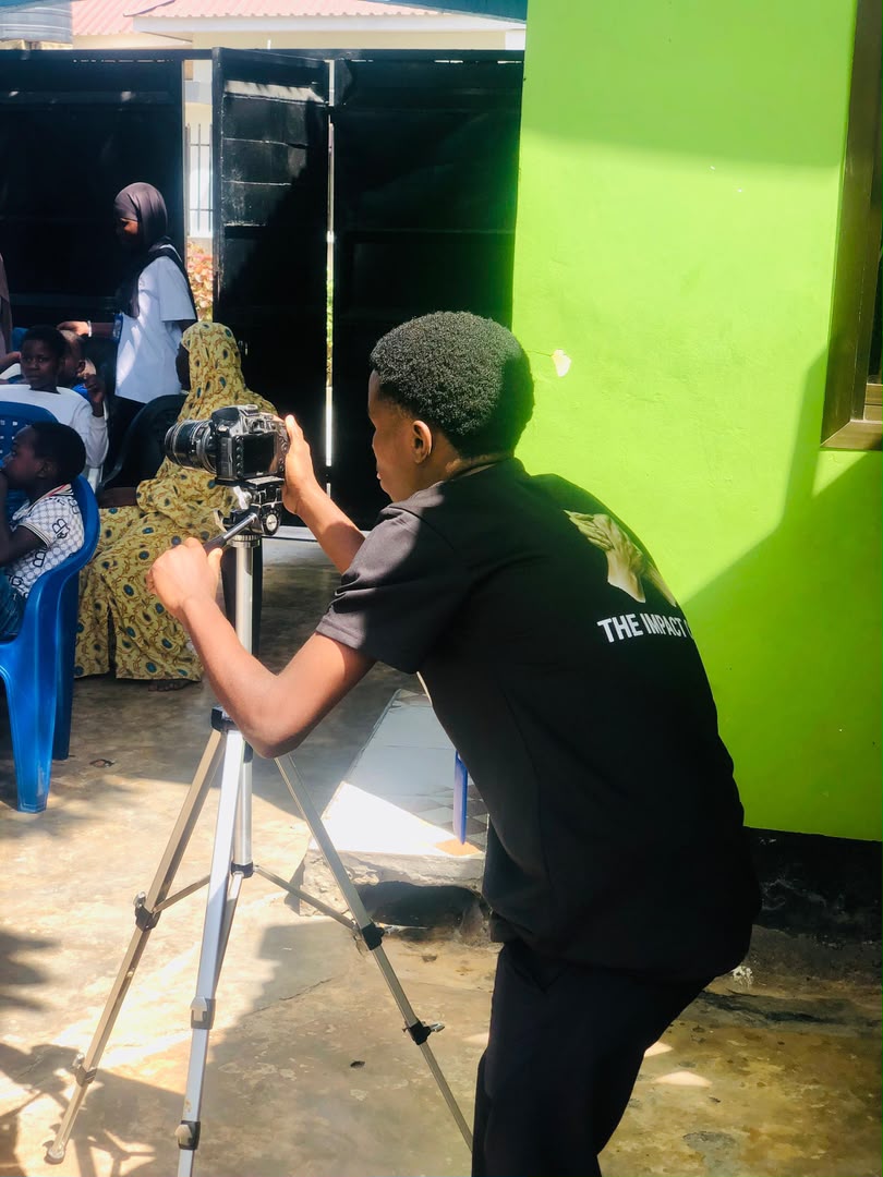 Young volunteer practising camera and media skills