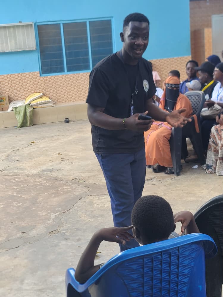 Founder of Impact Orphanage speaking with children during a skills session