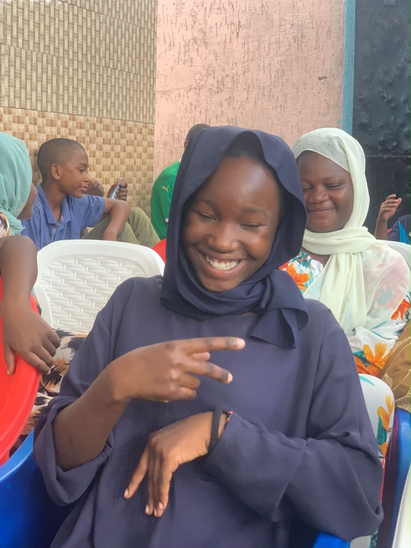 Young participant smiling during a community activity
