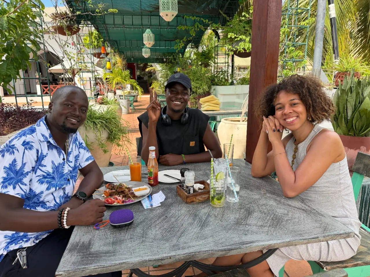 Guests enjoying drinks and skewers together at a garden cafe table